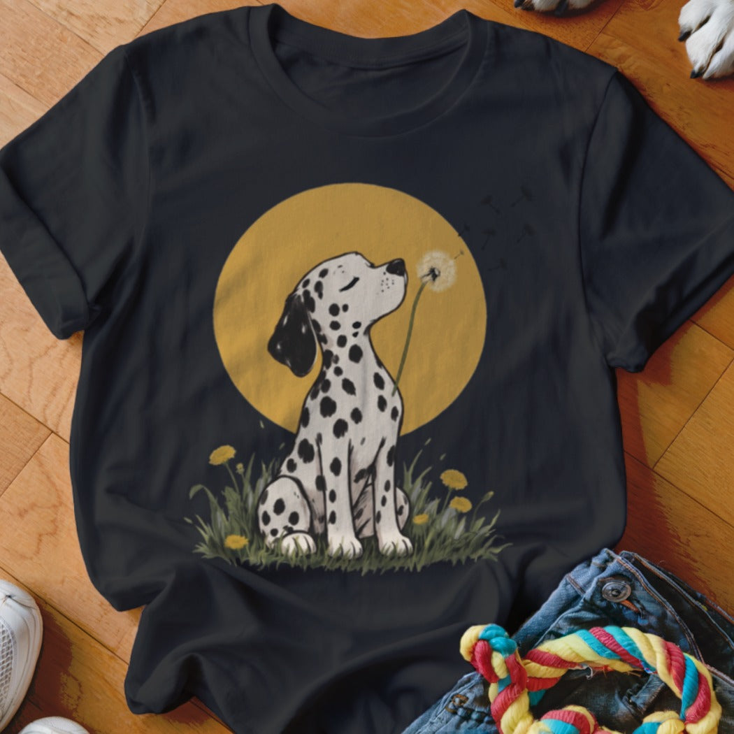 A black t-shirt features a graphic of a Dalmatian puppy blowing dandelion seeds against a yellow circle.
