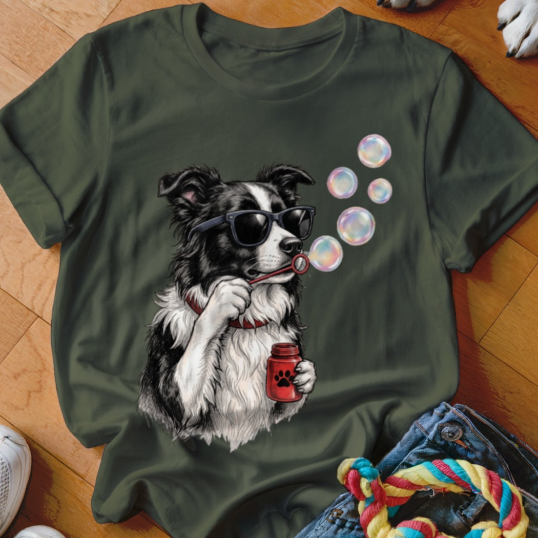 Dark green t-shirt featuring an illustration of a Border Collie wearing sunglasses and blowing bubbles.