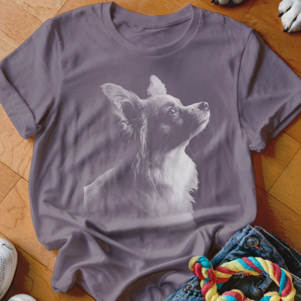 Purple t-shirt with a light gray graphic of a long-haired chihuahua looking up.