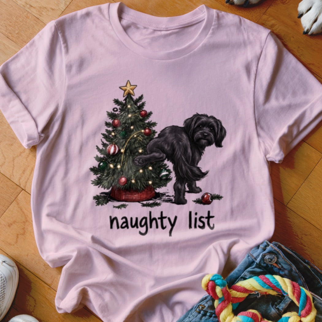 Black dog with paw raised at a Christmas tree, text reads "naughty list."