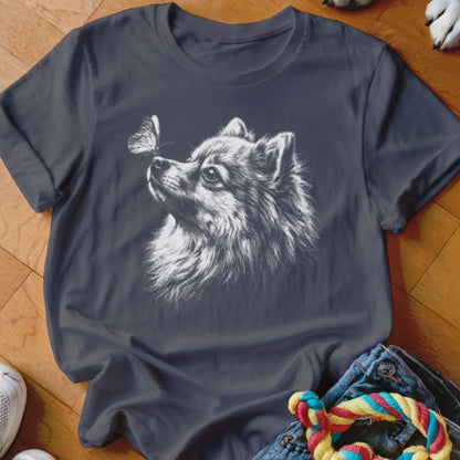 Charcoal grey t-shirt featuring a white sketch graphic of a Pomeranian dog looking at a butterfly.