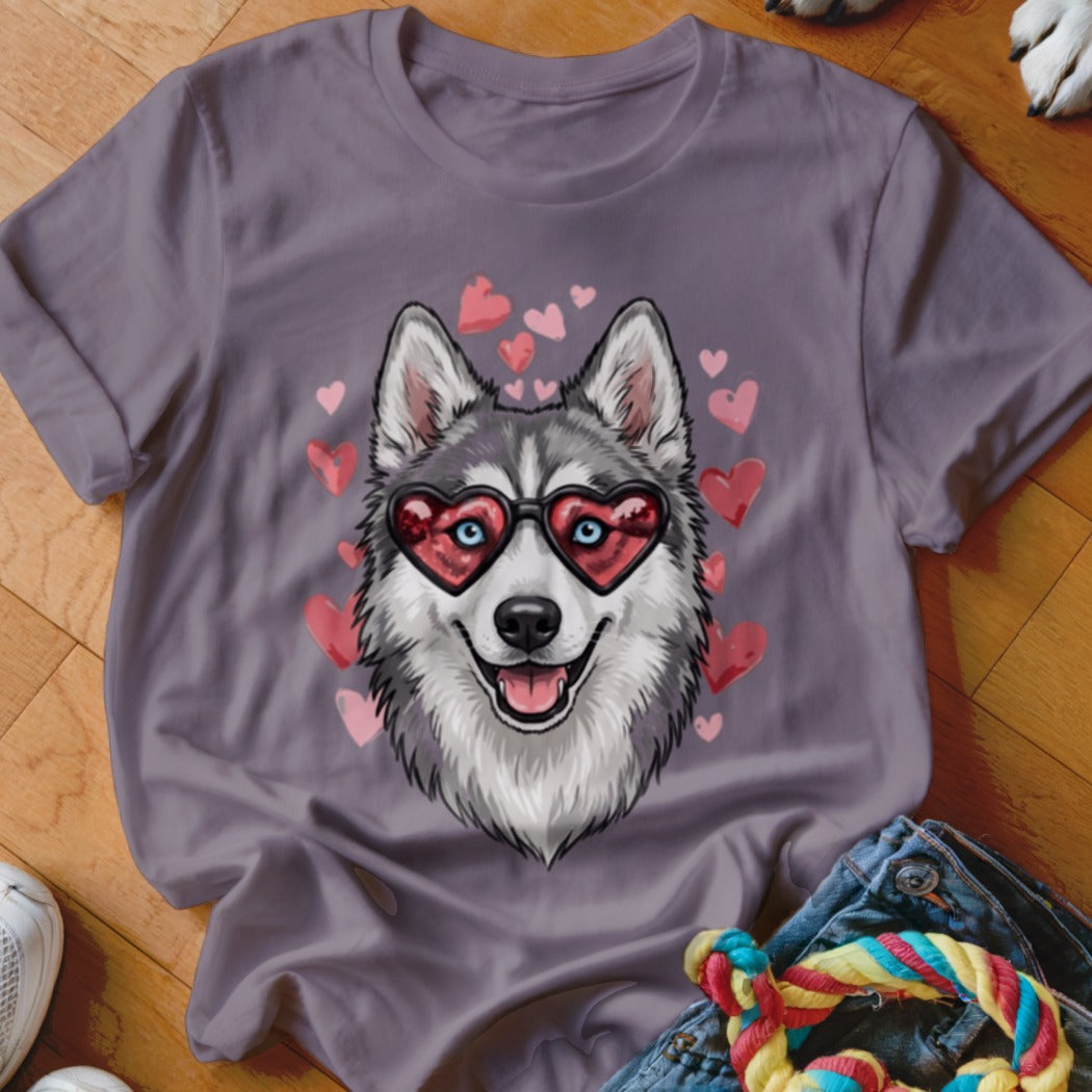 A purple t-shirt featuring a graphic of a husky wearing heart-shaped sunglasses surrounded by pink hearts.