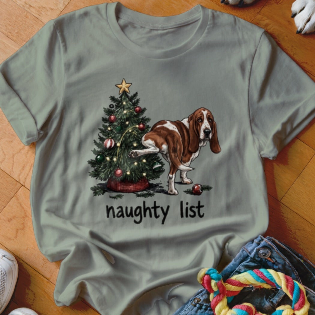 Basset hound next to a Christmas tree with text that says "naughty list."