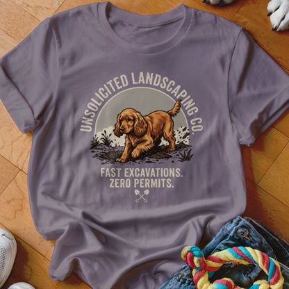 T-shirt graphic: dog digging with text "UNSOLICITED LANDSCAPING CO. FAST EXCAVATIONS. ZERO PERMITS."