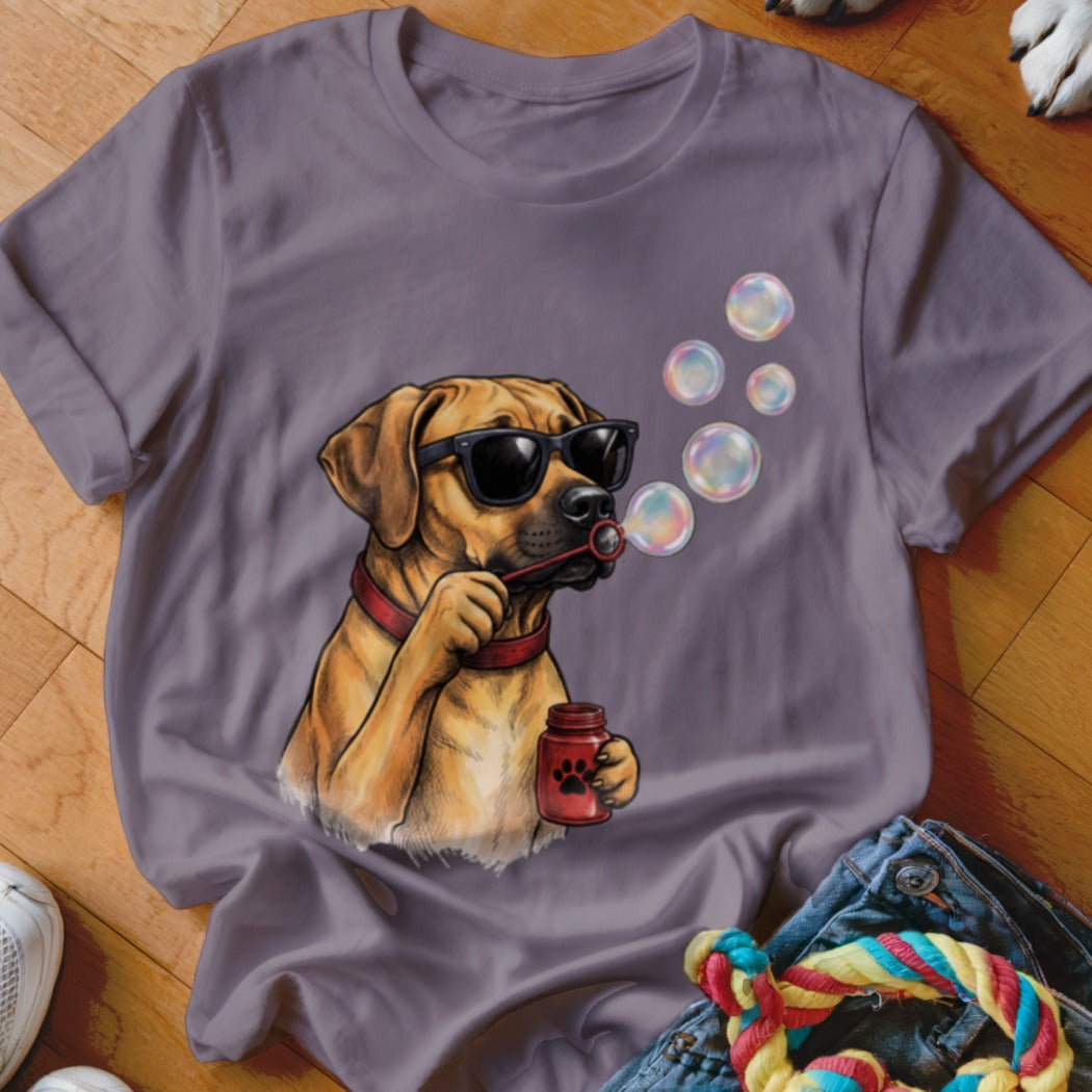 A grey short-sleeved t-shirt features an illustration of a brown dog wearing sunglasses and blowing bubbles.