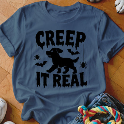 Blue t-shirt with "Creep It Real" text, a black dog silhouette, bats and spiders.