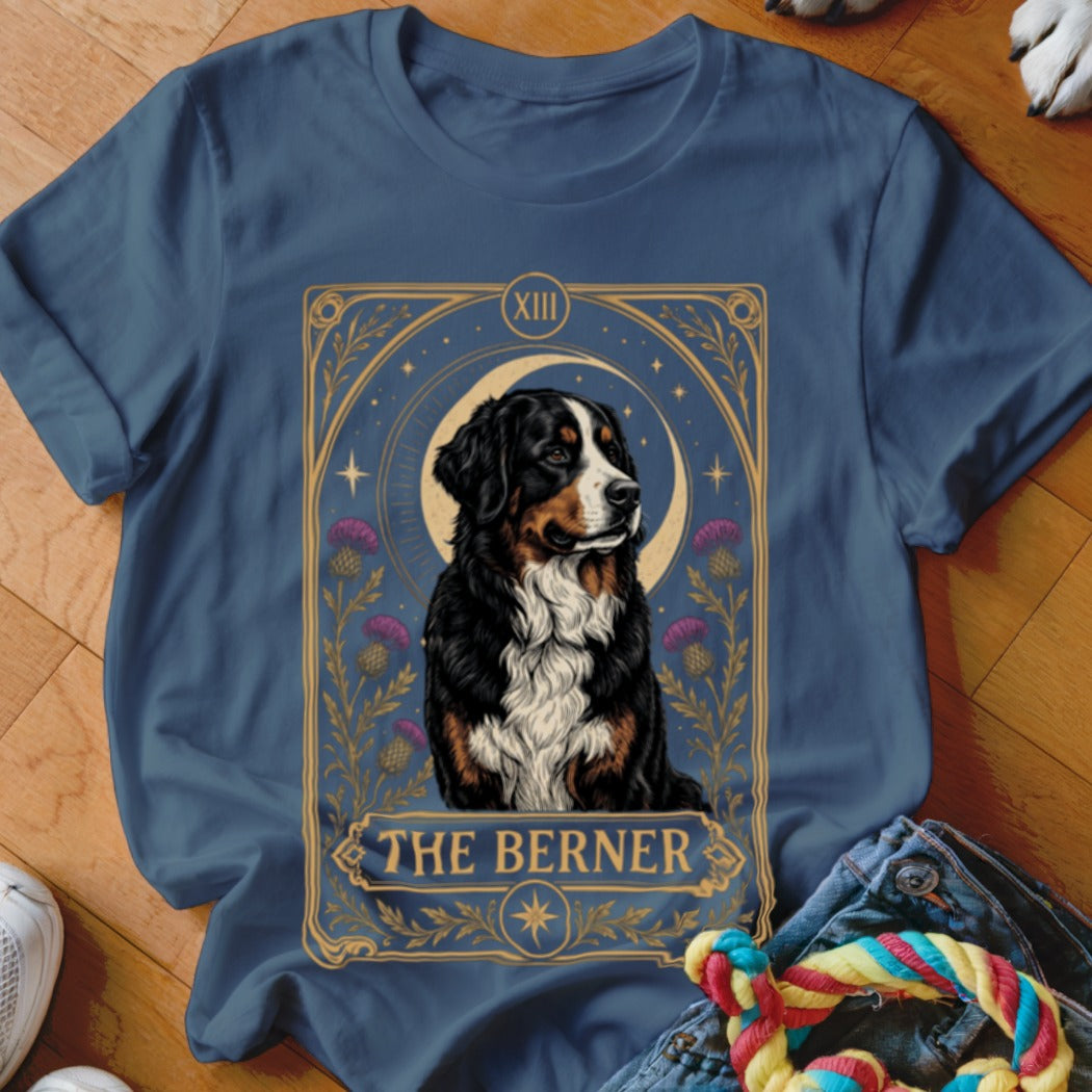 A dark blue t-shirt featuring a tarot card graphic of a Bernese Mountain Dog with the text The Berner.