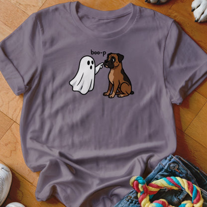 A ghost "boop-s" a boxer dog on a purple t-shirt with text.