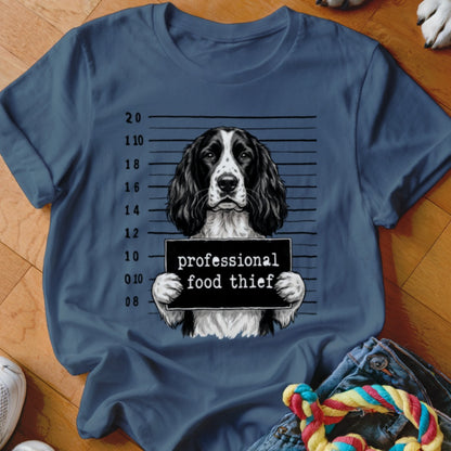 T-shirt graphic of a dog in a mugshot with "professional food thief" text.