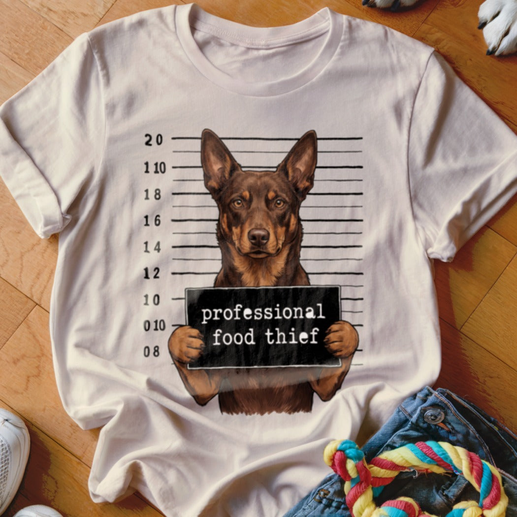 T-shirt with a dog in a mugshot holding a "professional food thief" sign.