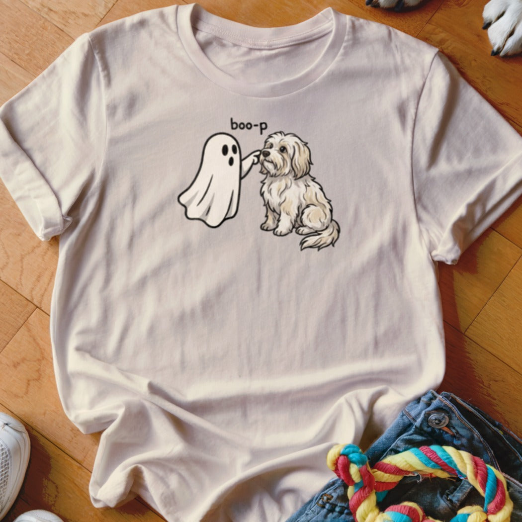 Ghost "boop-ing" a shaggy dog on a cream t-shirt.