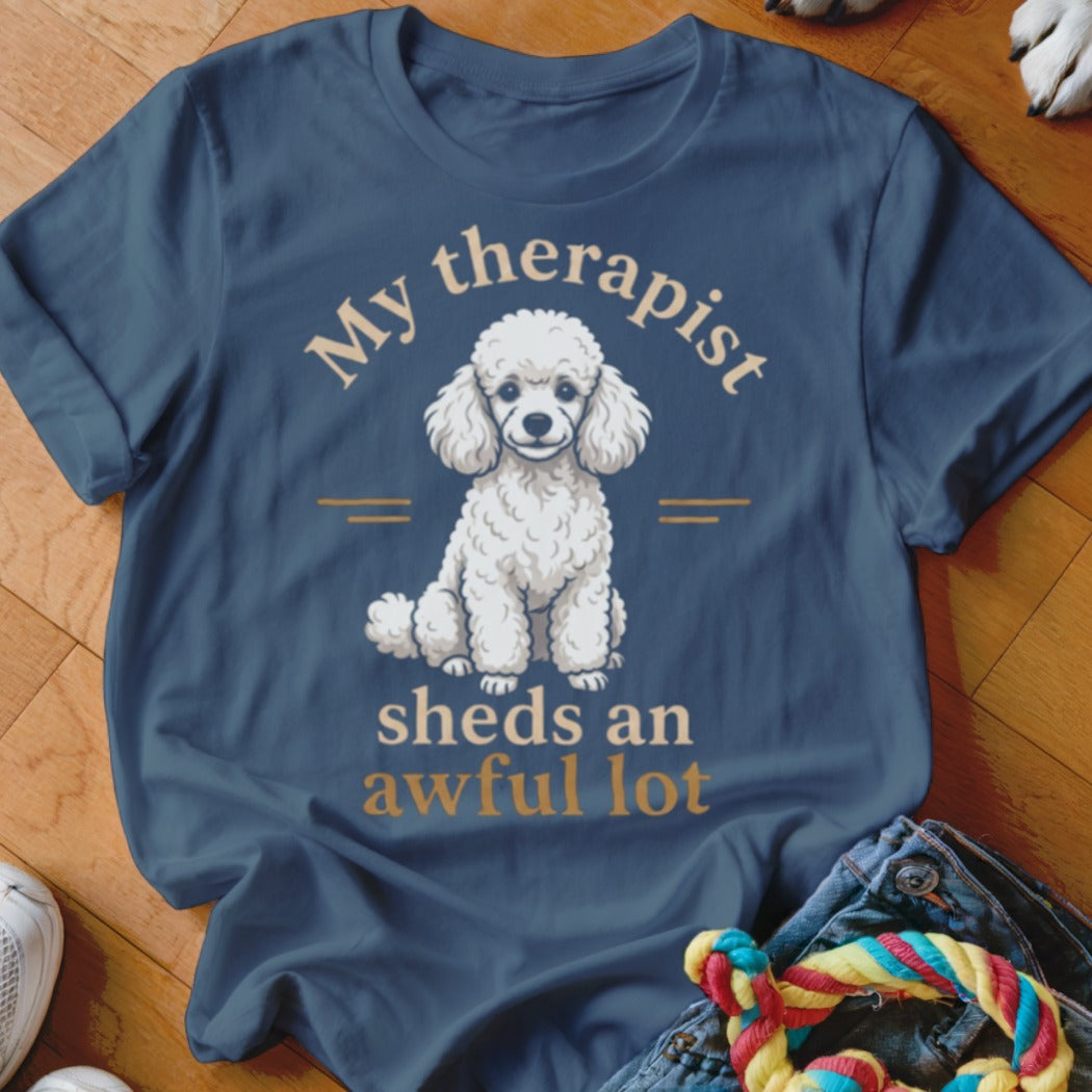 Dark blue t-shirt with white poodle illustration and text "My therapist sheds an awful lot".