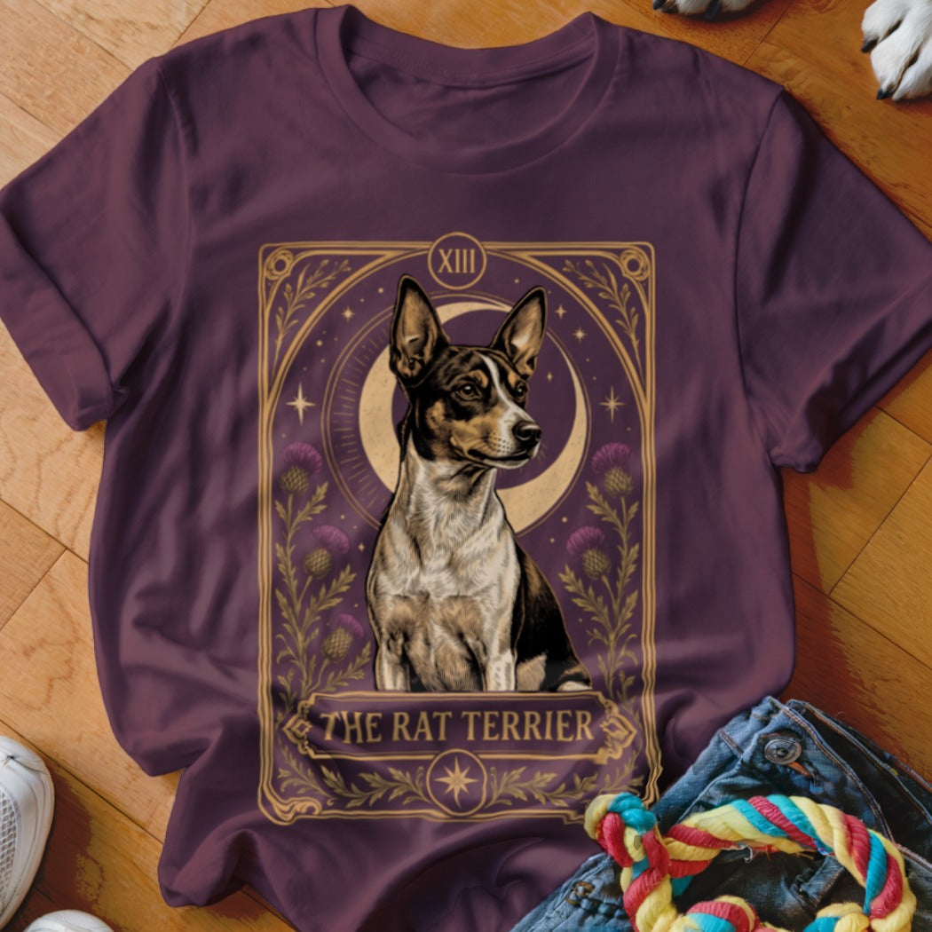 A dark plum t-shirt featuring a tarot-style graphic of a Rat Terrier surrounded by thistle flowers.