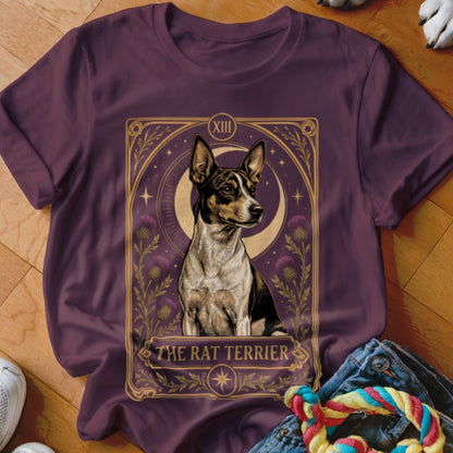 A dark plum t-shirt featuring a tarot-style graphic of a Rat Terrier surrounded by thistle flowers.