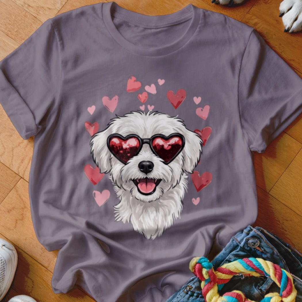 A grey t-shirt featuring a graphic of a white dog wearing heart-shaped sunglasses surrounded by floating hearts.
