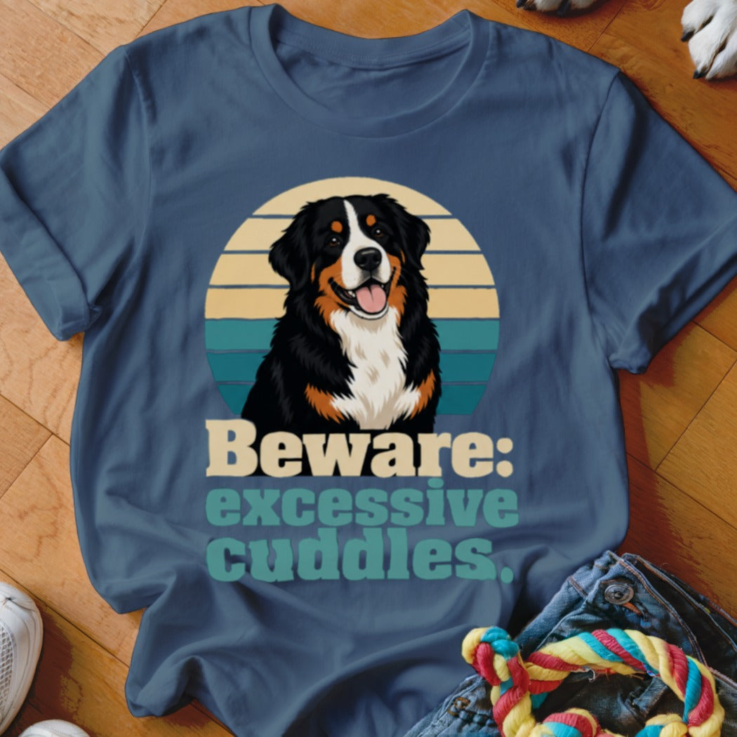 Bernese Mountain Dog wearing a t-shirt that says "Beware: excessive cuddles".