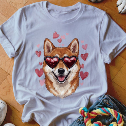 A white t-shirt featuring a graphic of a Shiba Inu wearing heart-shaped sunglasses surrounded by pink hearts.