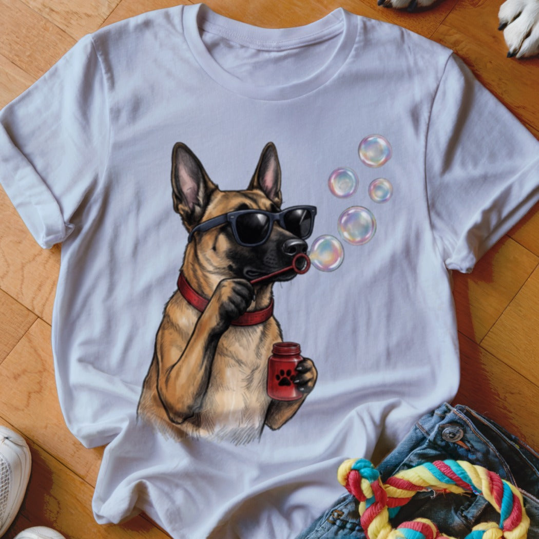 A white short-sleeved t-shirt featuring a graphic of a Belgian Malinois wearing sunglasses and blowing bubbles.