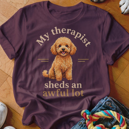 Maroon t-shirt with a poodle graphic and text "My therapist sheds an awful lot."