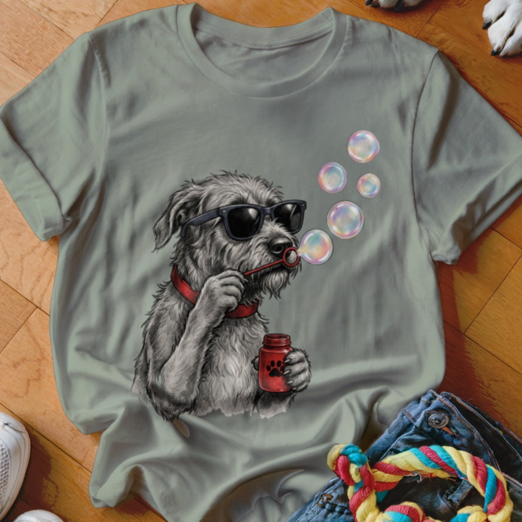 Sage green t-shirt featuring a graphic of a scruffy dog in sunglasses blowing bubbles.