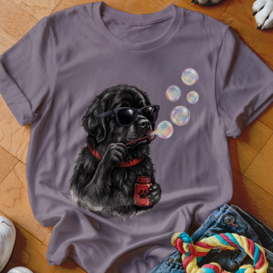 A gray t-shirt featuring a graphic of a black dog wearing sunglasses and blowing bubbles.