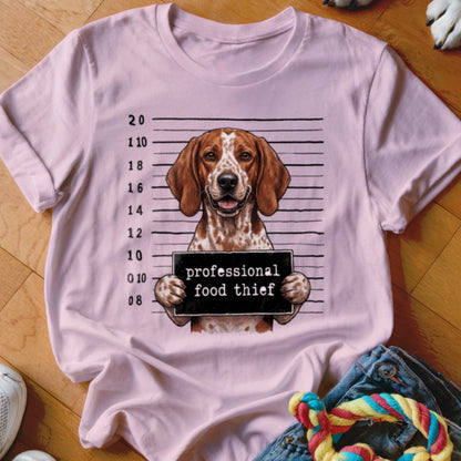 Pink t-shirt with a dog holding a "professional food thief" sign in front of a police lineup background.