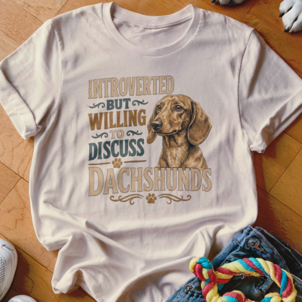 Cream t-shirt with dachshund graphic and "Introverted but willing to discuss Dachshunds" text.