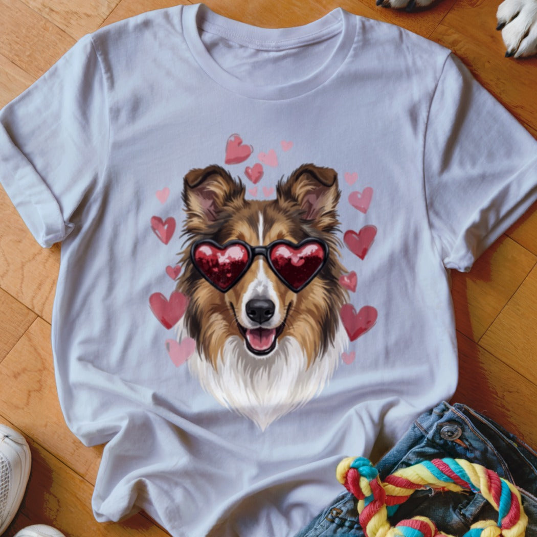 A light gray crewneck t-shirt featuring a graphic of a brown dog wearing heart-shaped sunglasses, surrounded by pink hearts.