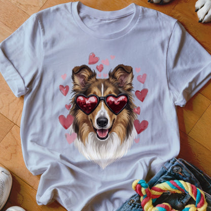 A light gray crewneck t-shirt featuring a graphic of a brown dog wearing heart-shaped sunglasses, surrounded by pink hearts.
