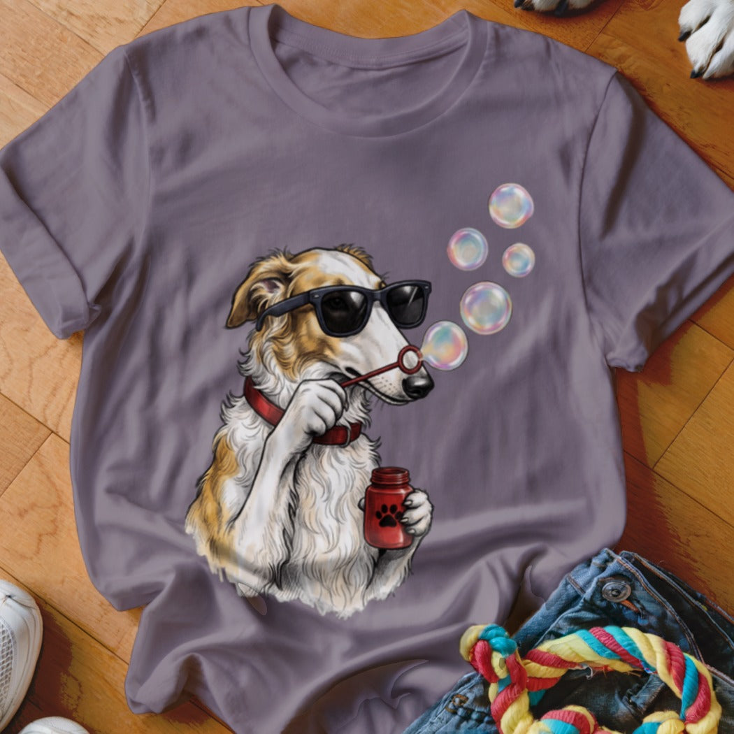 Grey t-shirt featuring an illustration of a dog wearing sunglasses and blowing soap bubbles.