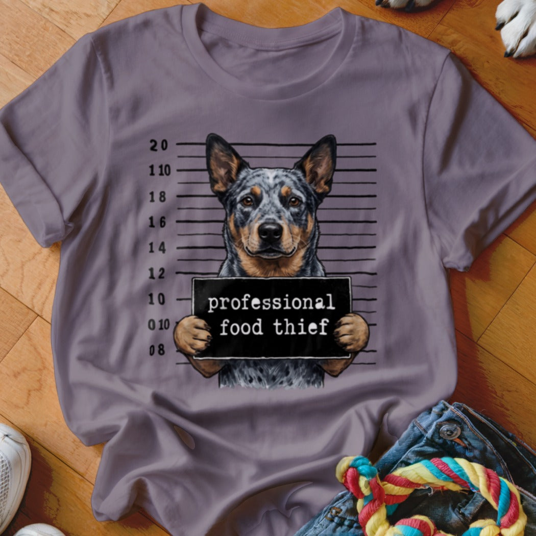 Gray t-shirt with a blue heeler dog mugshot holding a sign "professional food thief".