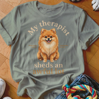 Light green t-shirt with a Pomeranian dog and text "My therapist sheds an awful lot".