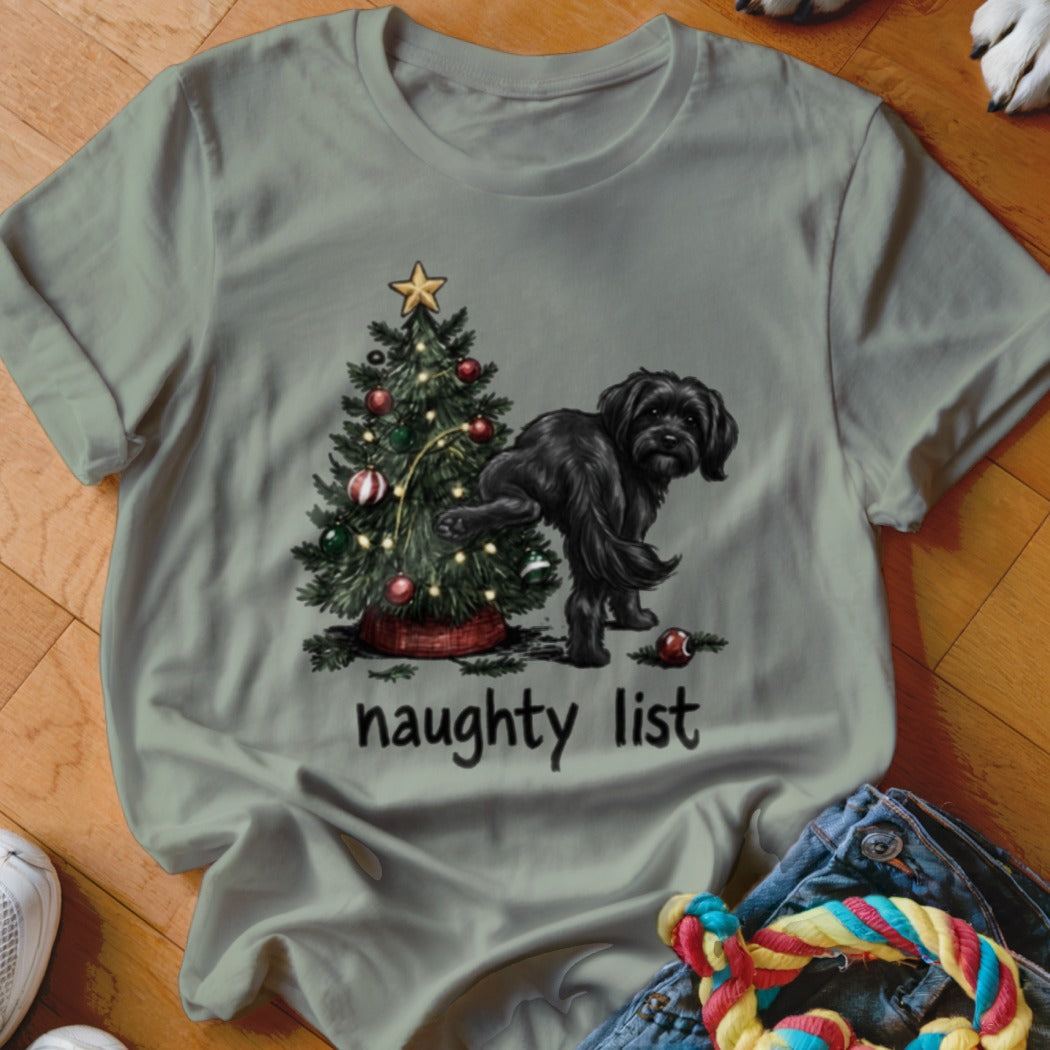Black dog lifting leg near Christmas tree with "naughty list" text.