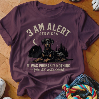 T-shirt with a Doberman, house, and trees at night with text.