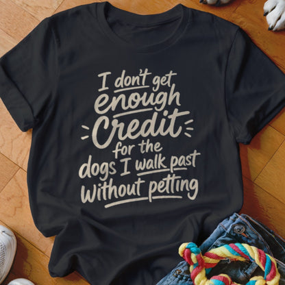 A black crew-neck t-shirt with white text that reads, I don't get enough credit for the dogs I walk past without petting.