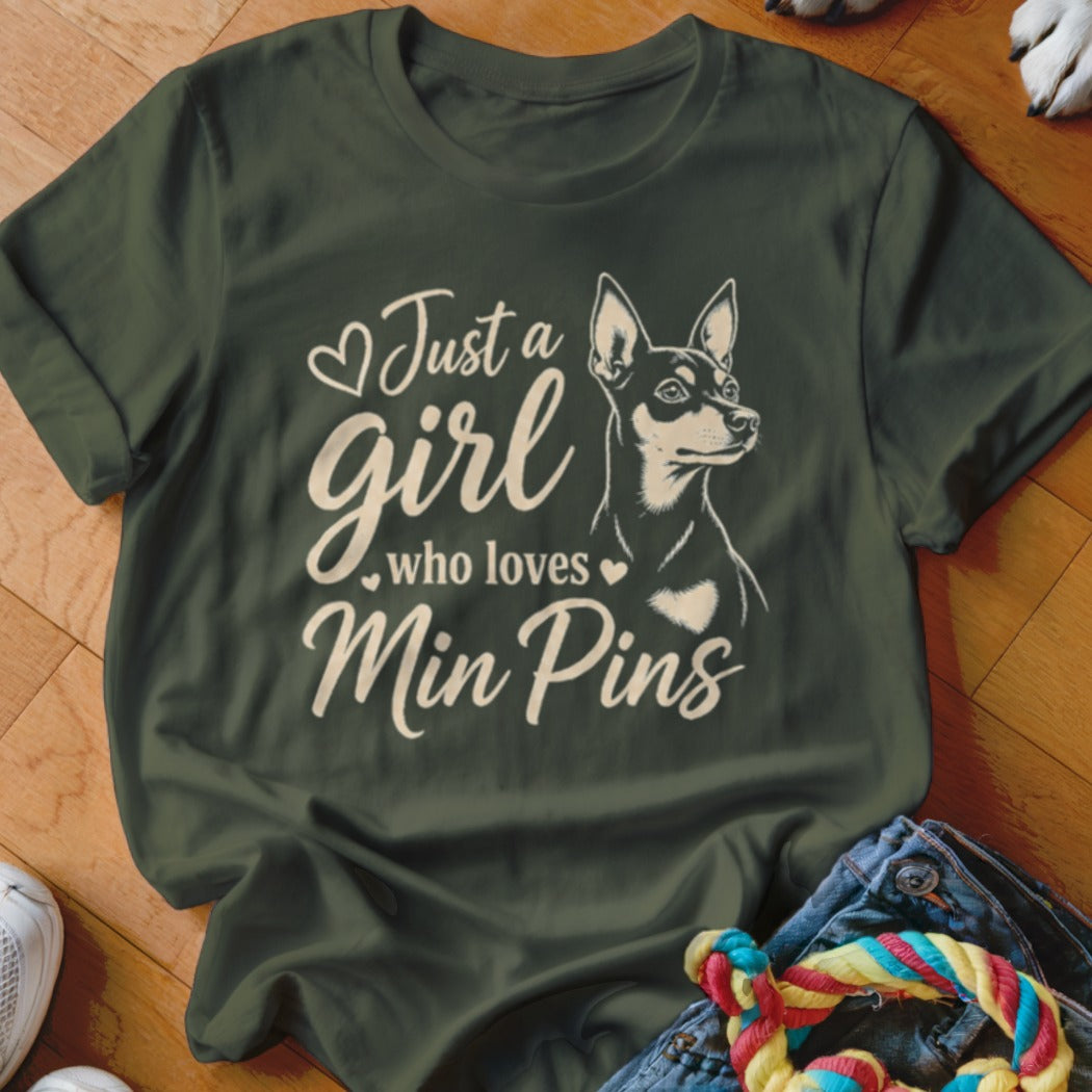 Olive green t-shirt with "Just a girl who loves Min Pins" text and a dog illustration.