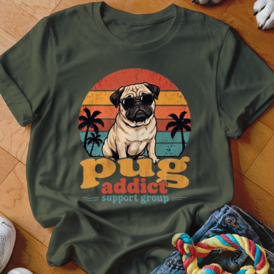 Dark green t-shirt featuring a retro sunset graphic, pug wearing sunglasses, and the text Pug Addict Support Group.