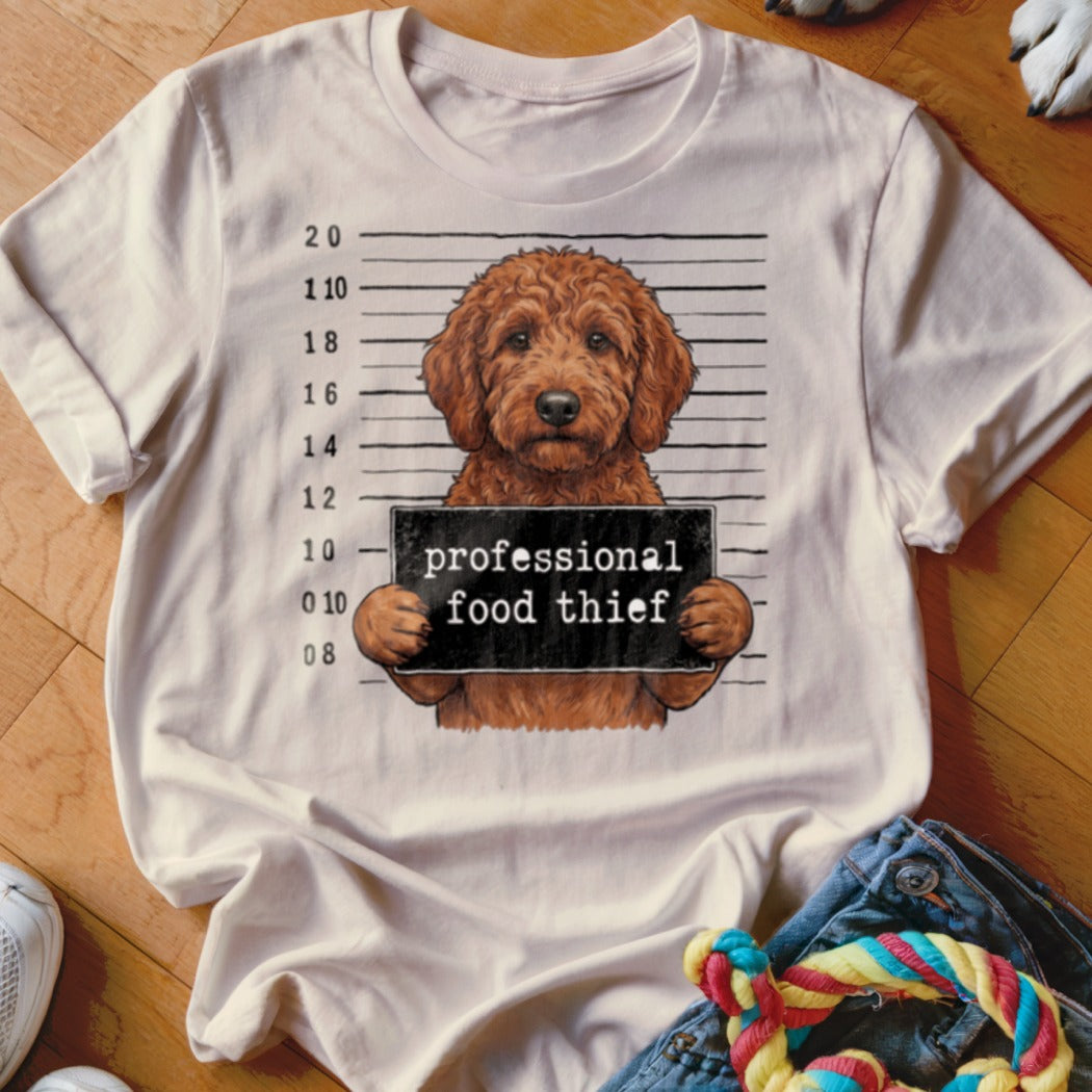 Goldendoodle dog mugshot with text "professional food thief".