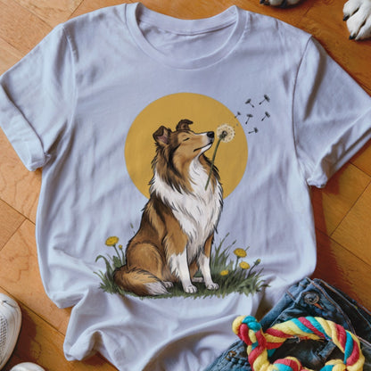 A white crewneck t-shirt featuring an illustration of a collie dog sniffing a dandelion against a yellow circle background.