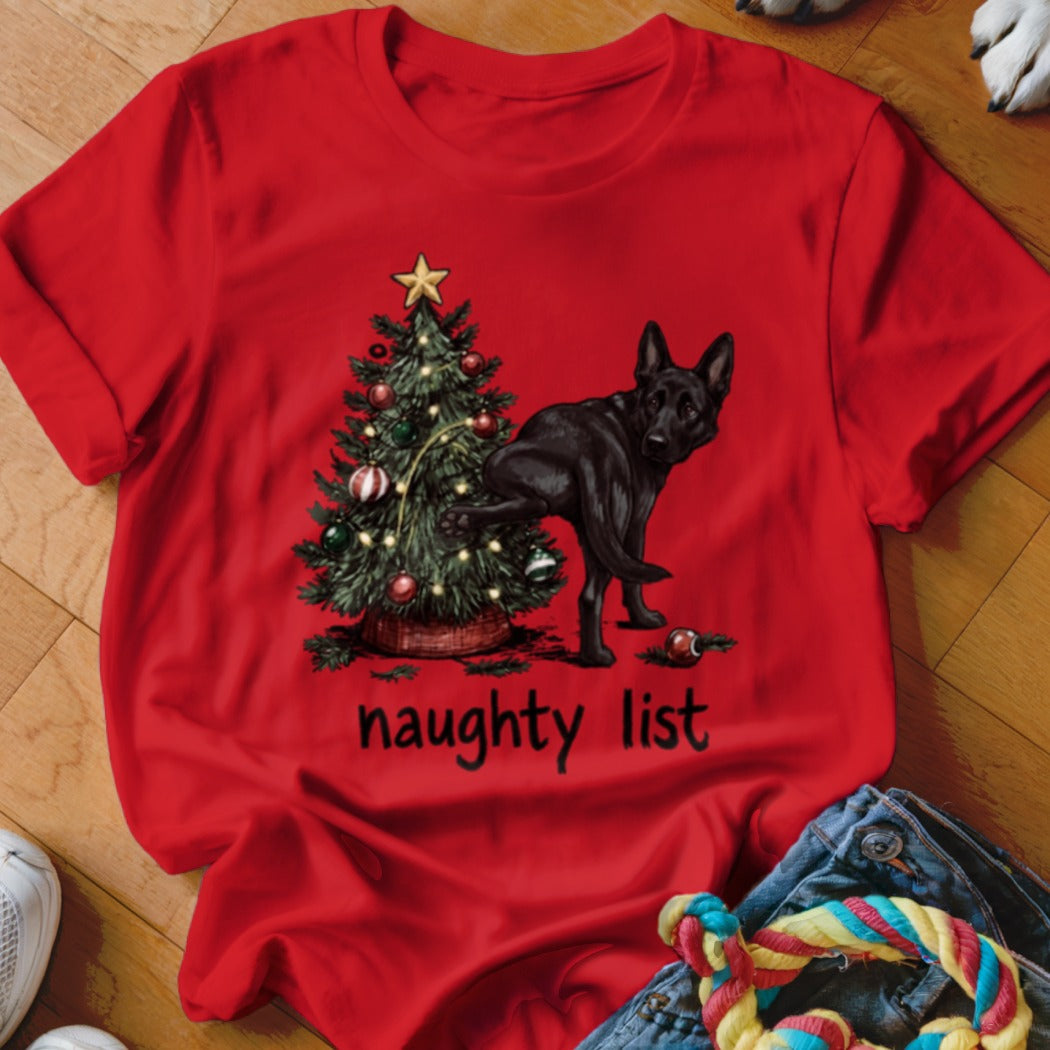 Black German Shepherd next to a Christmas tree with text "naughty list"