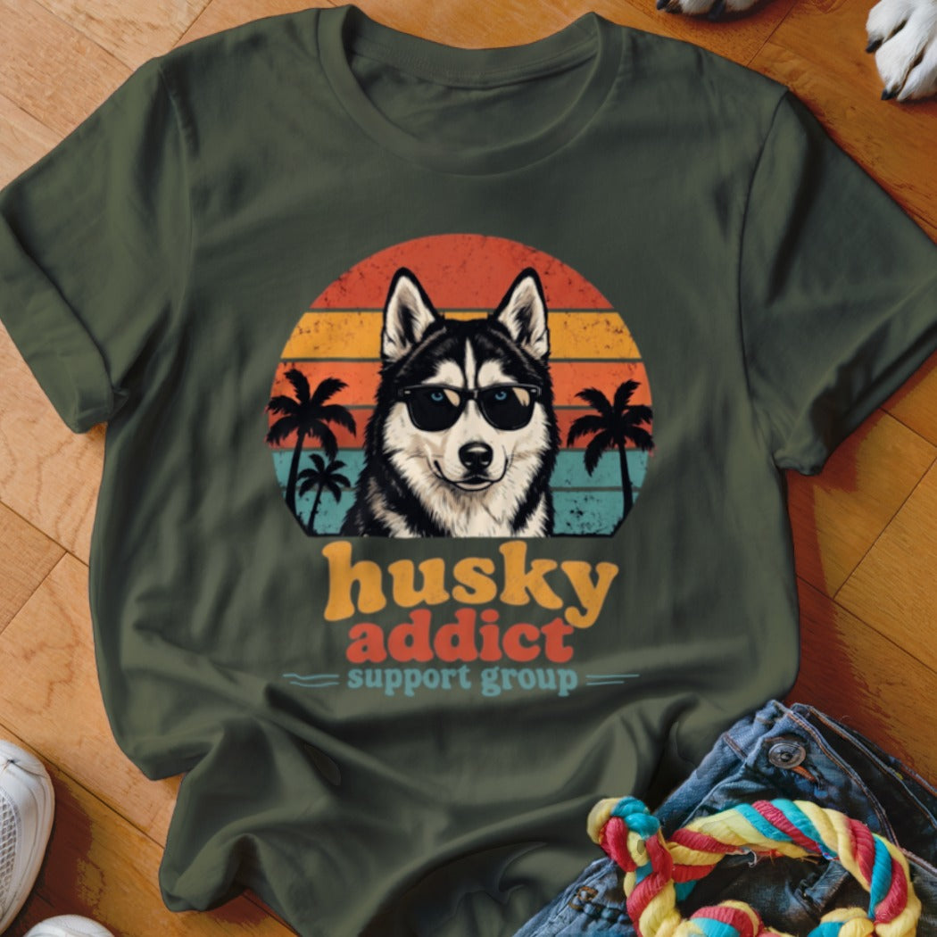 Dark green t-shirt featuring a retro graphic of a sunglasses-wearing husky with palm trees and sunset text.