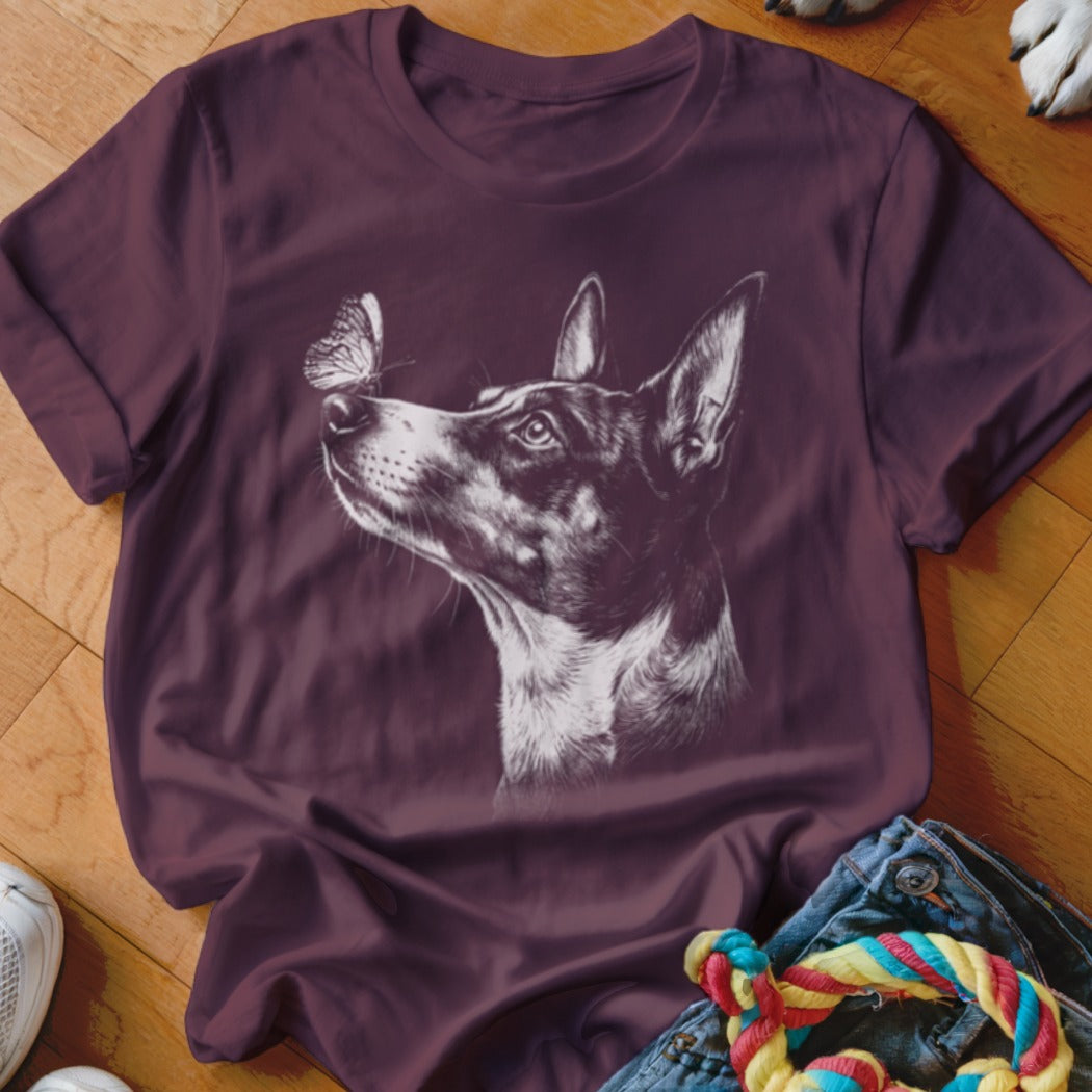 Maroon t-shirt featuring a white line drawing of a dog looking up at a butterfly.