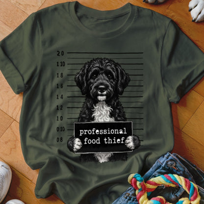 Black doodle dog mugshot with text "professional food thief".