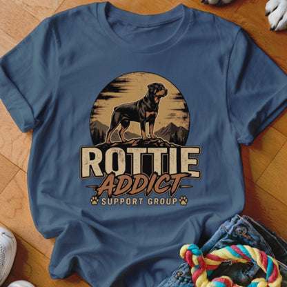 Blue t-shirt featuring a graphic of a Rottweiler standing on a mountain with the text "Rottie Addict Support Group".