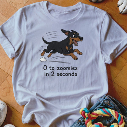 White t-shirt with cartoon dog running and text "0 to zoomies in 2 seconds".
