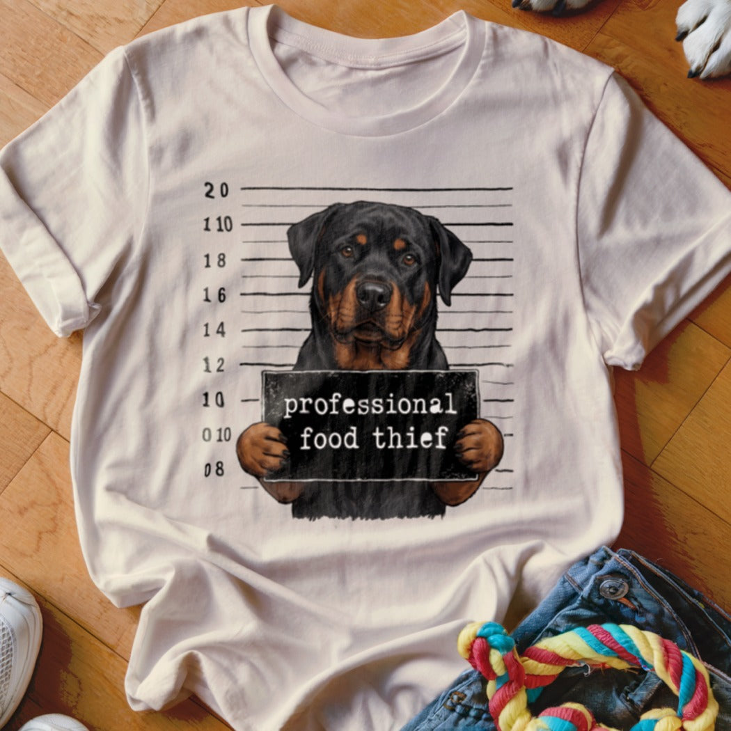 Rottweiler mugshot with sign reading "professional food thief".