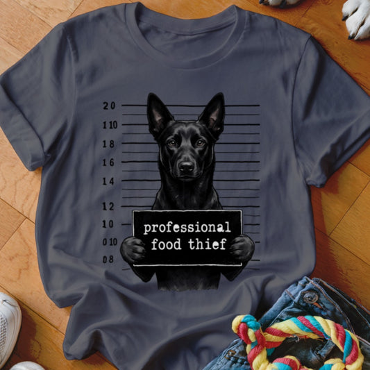 Black dog mugshot with "professional food thief" sign on a dark grey t-shirt.