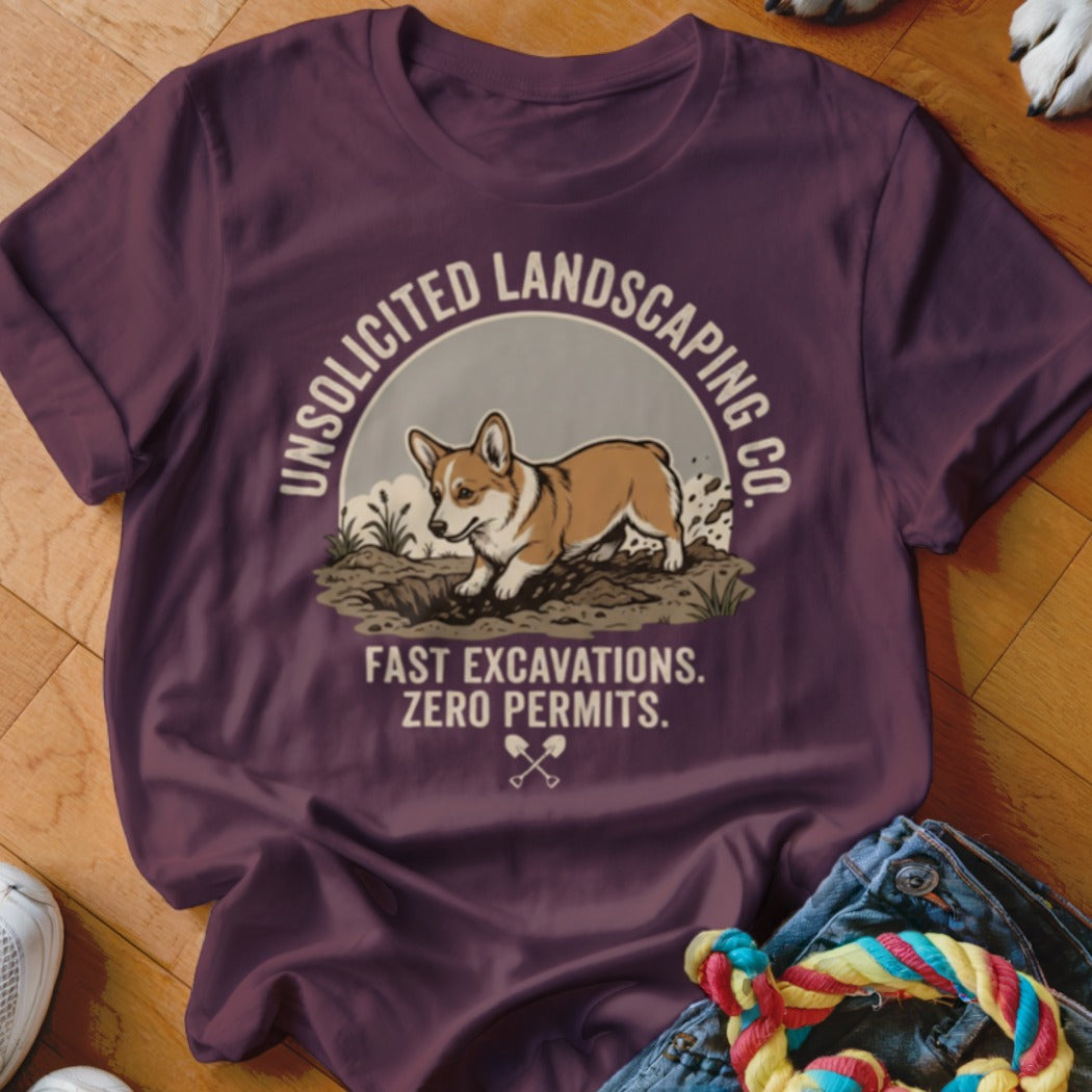 T-shirt graphic with a corgi digging, text "UNSOLICITED LANDSCAPING CO. FAST EXCAVATIONS. ZERO PERMITS."