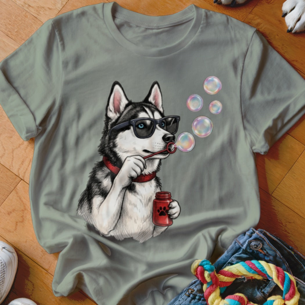 Sage green crewneck t-shirt featuring an illustrated husky wearing sunglasses and blowing soap bubbles.