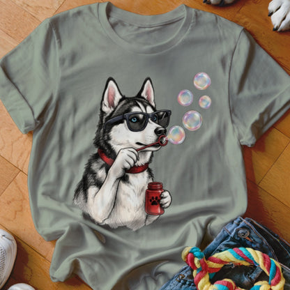 Sage green crewneck t-shirt featuring an illustrated husky wearing sunglasses and blowing soap bubbles.